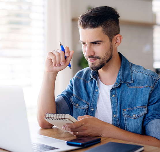 A first time home owner applying for the First Home Loan Deposit Scheme using a laptop.