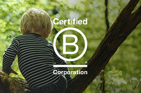 A small child climbs a tree in a green forest. The 'Certified B Corporation' is overlaid on the right.
