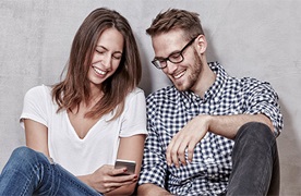 Young couple banking on their mobile phone 