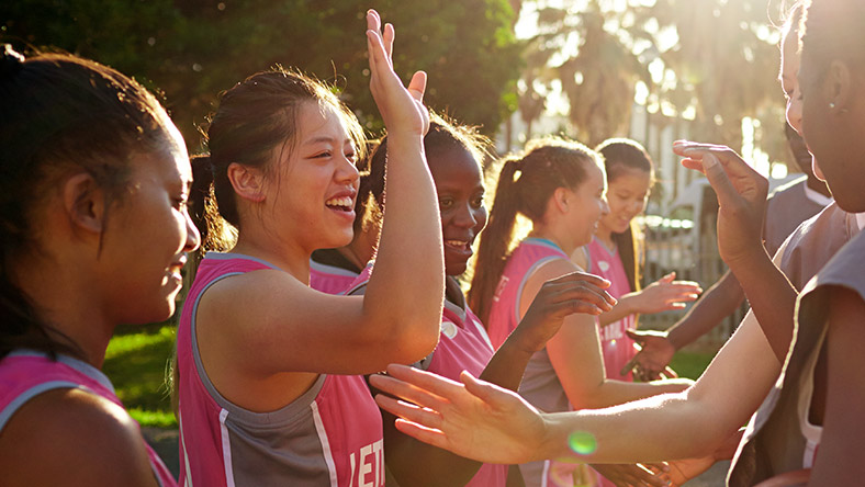 A group of students playing a team sport.