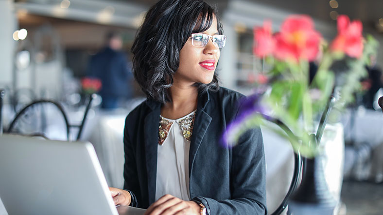 Woman considering her ethical investment options on laptop