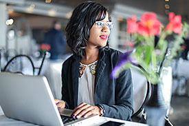 Woman considering her ethical investment options on laptop