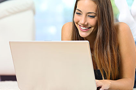 Woman at home shopping online on her laptop.