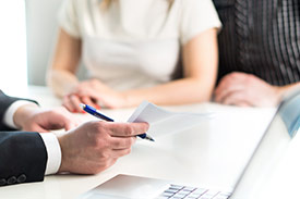 A young defacto couple working with a tax agent to complete their tax return