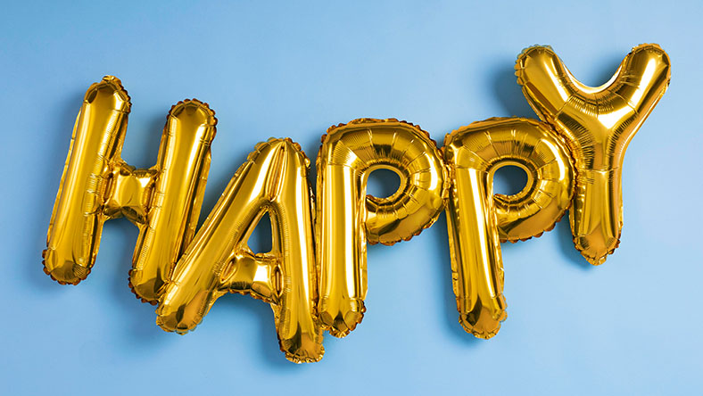 Five gold balloons spell out the word happy.