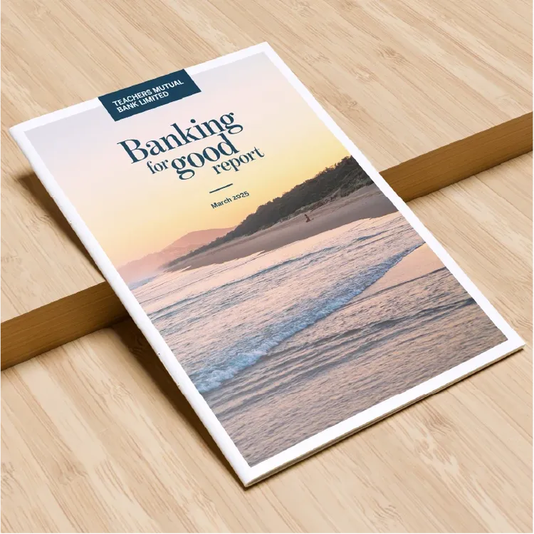 A printed report titled 'Banking for good report' is placed on a light wooden surface.